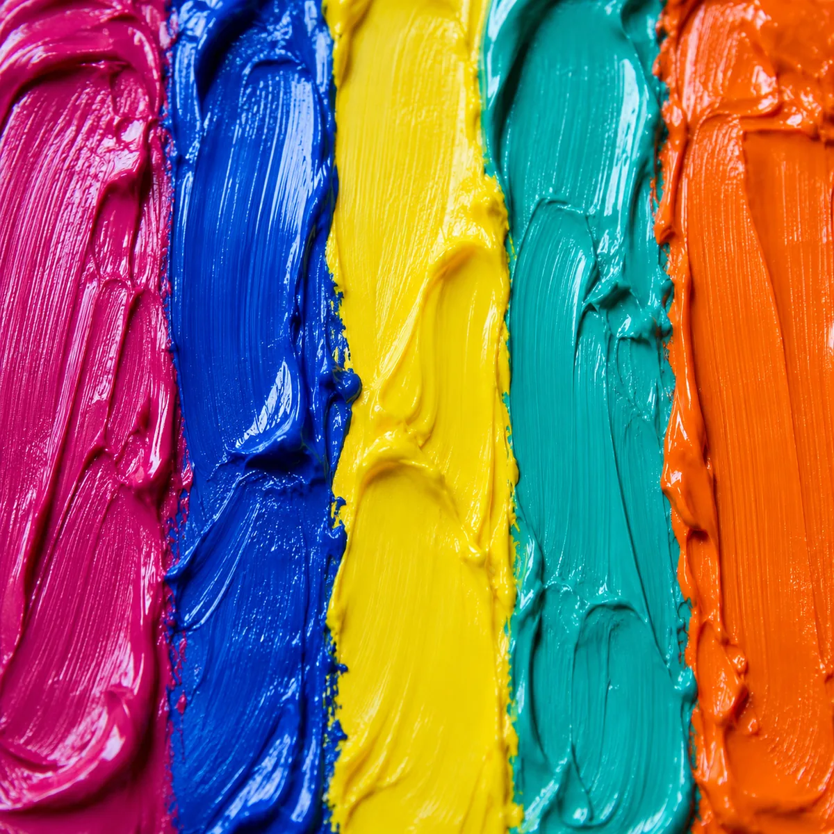 Five broad strokes of thick paint side by side: magenta, blue, yellow, turquoise, and orange.